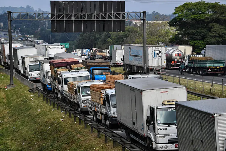 Truck drivers block the Regis Bittencourt road, 30 km from Sao Paulo, on May 26, 2018 during a strike to protest rising fuel costs in Brazil that has left much of the country paralyzed. - Brazil's government raised the stakes in its tense standoff with striking truckers Friday, ordering troops onto the streets to clear the huge blockades. The country's economic capital of Sao Paulo declared a state of emergency, the auto industry shut down, gas stations ran out of fuel and dozens of flights were canceled on the fifth day of the protest Friday. (Photo by Nelson ALMEIDA / AFP)        (Photo credit should read NELSON ALMEIDA/AFP via Getty Images) (NELSON ALMEIDA/AFP via Getty Images/Getty Images)