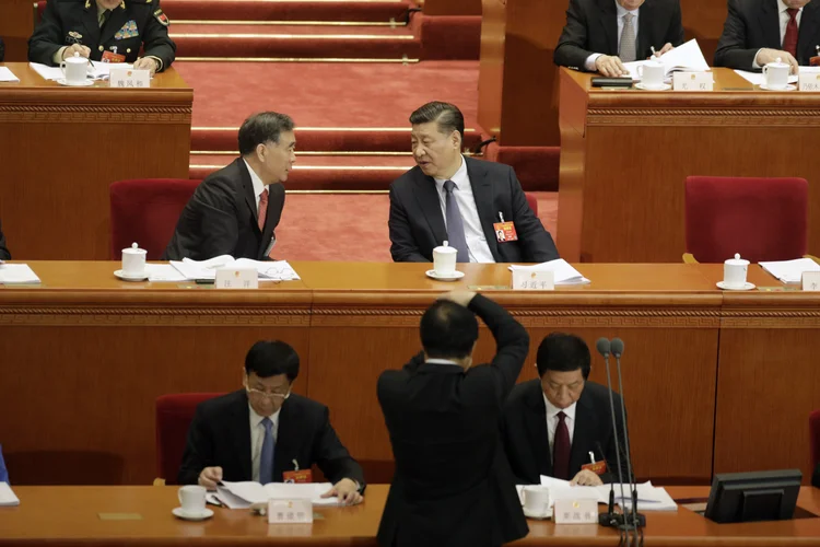 Xi Jinping, China's president, center right, speaks with Wang Yang, member of the the Communist Party of China's Politburo Standing Committee, during the opening of the Second Session of the 13th National People's Congress (NPC) at the Great Hall of the People in Beijing, China, on Tuesday, March 5, 2019. China lowered its goal for economic growth and announced a major tax cut, as policymakers seek to pull off a gradual deceleration while grappling with a debt legacy and the trade standoff with the U.S. Photographer: Qilai Shen/Bloomberg via Getty Images (Qilai Shen/Getty Images)