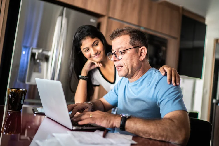 Father talking to father while he's working at home (FG Trade/Getty Images)