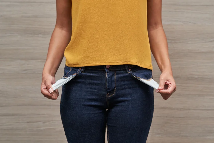 Unrecognizable young women showing her empty pockets without money. Concept of saving money and personal finance. (Getty Images/Getty Images)