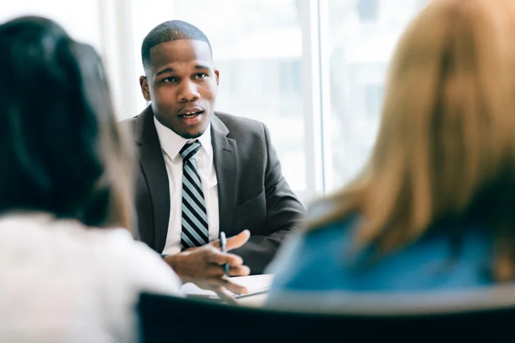 Two women at a meeting with a financial advisor (Getty/Getty Images)