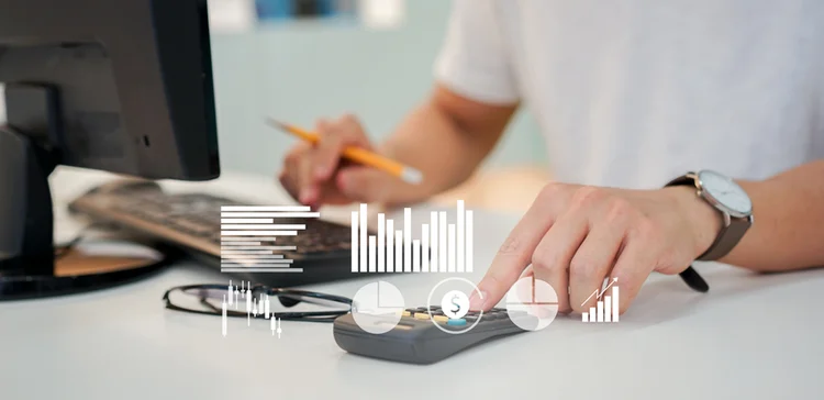 close up businessman accountant calculating on calculator to planning strategy and profit at desktop office workplace with dashboard tools monitor for data management of business financial and economy concept (Getty/Getty Images)