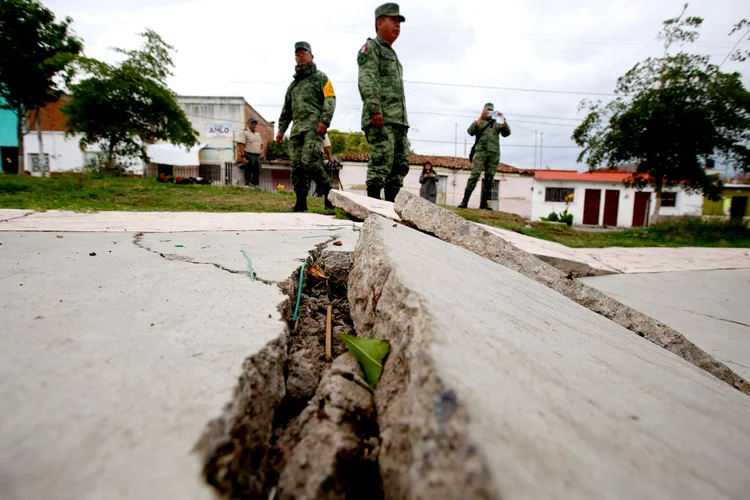 TOPSHOT - Members of the Mexican Army check cracks in the streets after an earthquake caused by a geological fault in Ciudad Guzman, Jalisco state, Mexico, on June 22, 2022. - Jalisco Civil Protection confirmed that an earthquake was reported in Ciudad Guzman, and  pointed out that it was a geological movement in the fault that runs through the Santa Rosa neighborhood of the municipality. (Photo by ULISES RUIZ / AFP) (Photo by ULISES RUIZ/AFP via Getty Images) (ULISES RUIZ/Getty Images)