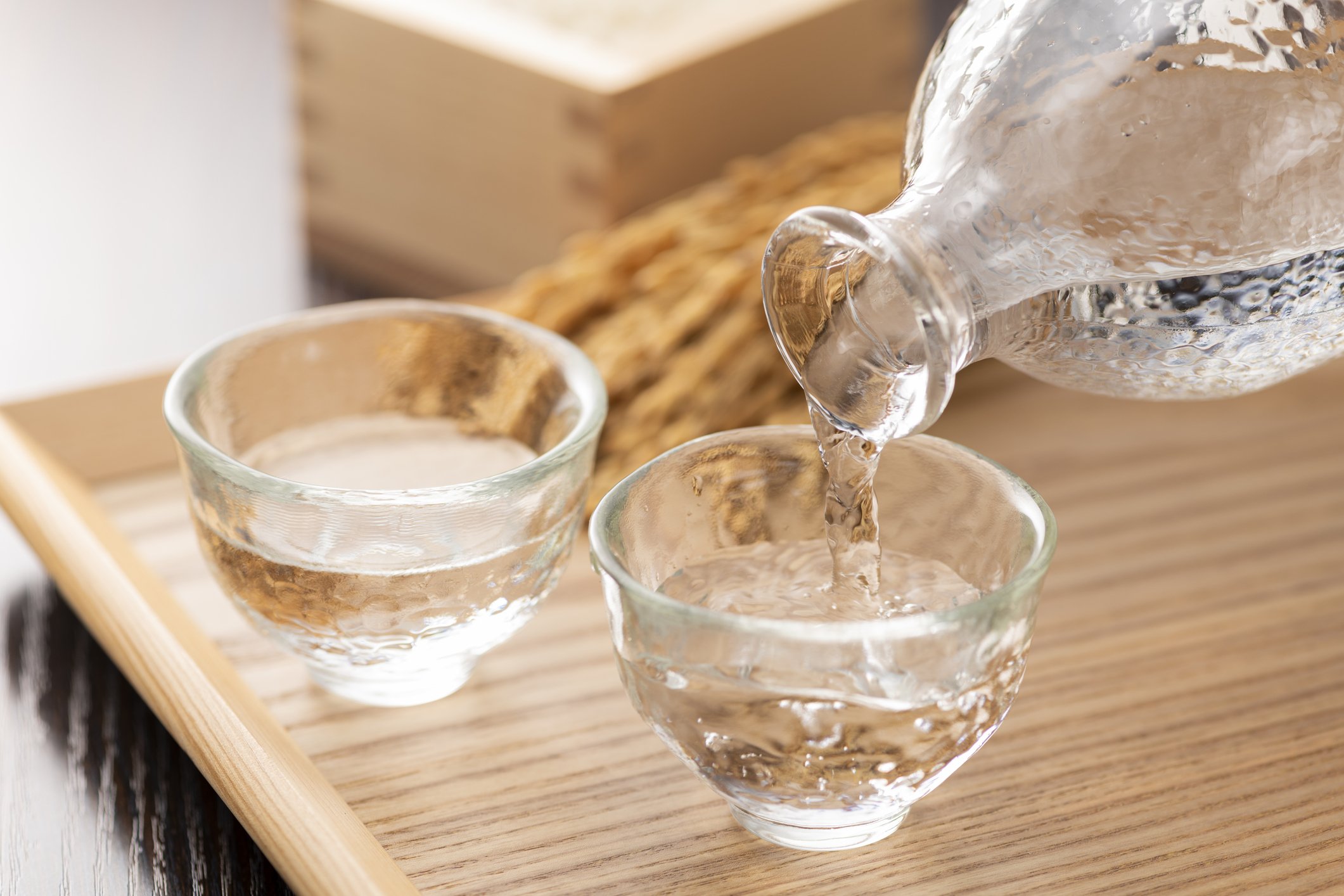 Cold sake with rice and ear of rice on the table