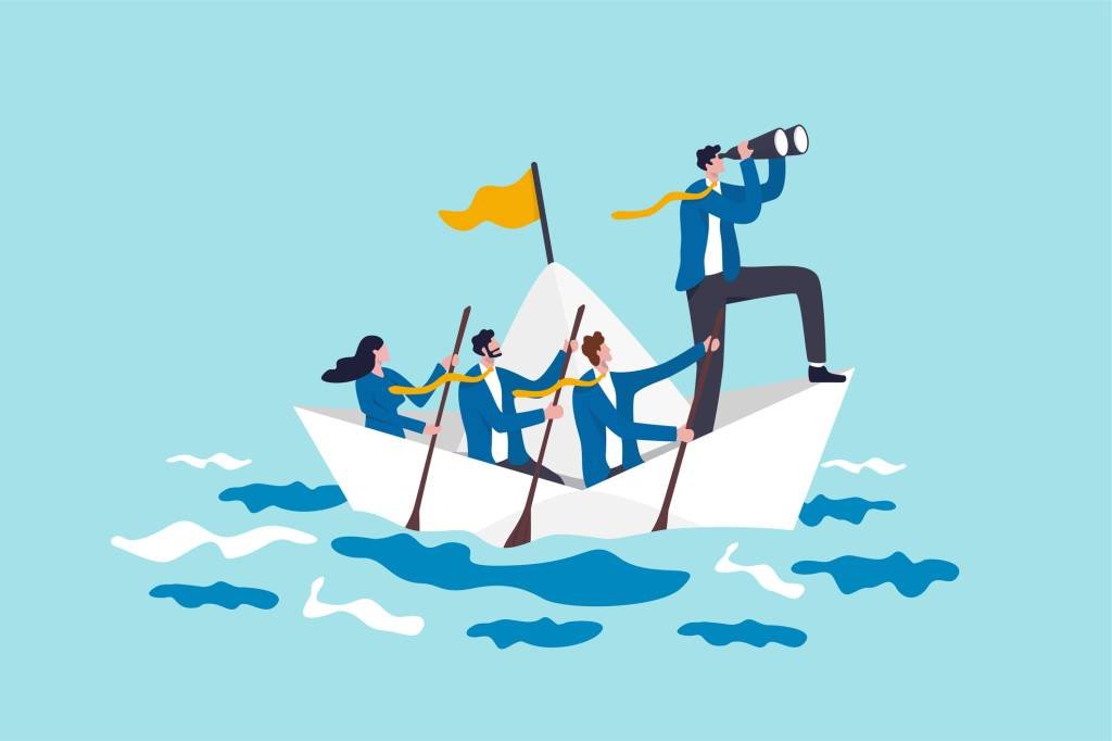 Leadership to lead business in crisis, teamwork or support to achieve target, vision or forward strategy for success concept, businessman leader with binoculars lead business team sailing origami ship (Nuthawut Somsuk/Getty Images)