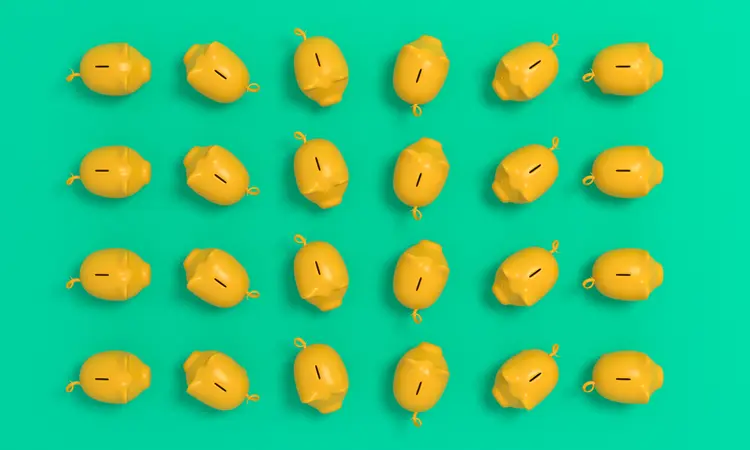 Multiple yellow piggy banks (GettyImages/Getty Images)