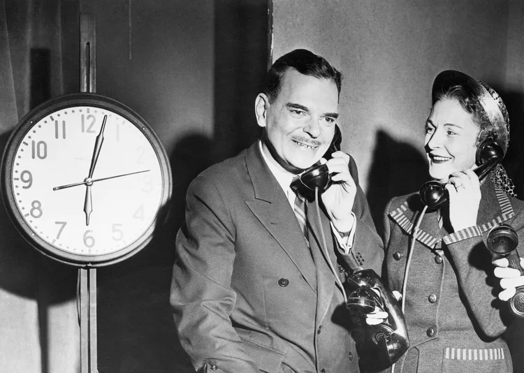 (Original Caption) 11/6/1950-New York, NY- Making an eleventh hour bid to win undecided voters to his side, Governor Thomas E. Dewey, running for re-election as Chief Executive of the Empire State, began a long day of broadcasting and televison appearances at station WOR-TV at 6 a.m. today. The schedule called for an 18-hour day for the Governor, who is shown answering one telephone here while Mrs. Dewey answers other phones. (NY/Getty Images)