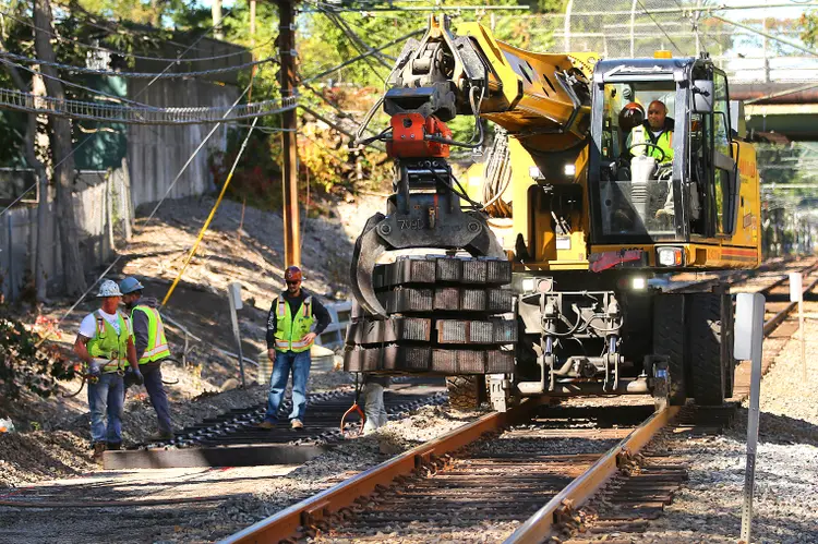 Newton, MA - September 24: Workers install new railroad ties at the Woodland T Station. (Photo by John Tlumacki/The Boston Globe via Getty Images) (John Tlumacki/Getty Images)