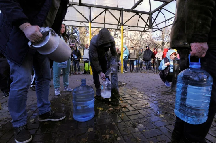 Kiev: Moradores da capital enchem garrafas com água de uma fonte pública em um parque, em 31 de outubro de 2022 (AFP/AFP)