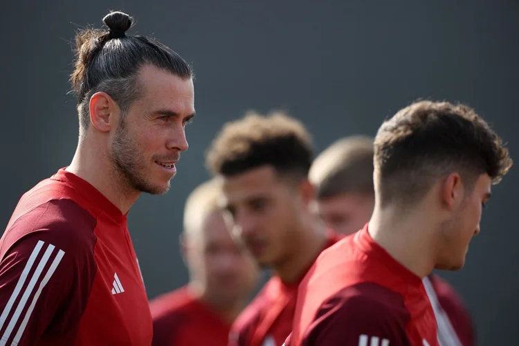 Wales' forward Gareth Bale (L) looks on during a training session at the Al Saad SC in Doha on November 20, 2022, on the eve of the Qatar 2022 World Cup football match between the USA and Wales. (Photo by Adrian DENNIS / AFP) (Photo by ADRIAN DENNIS/AFP via Getty Images) (ADRIAN DENNIS/AFP/Getty Images)