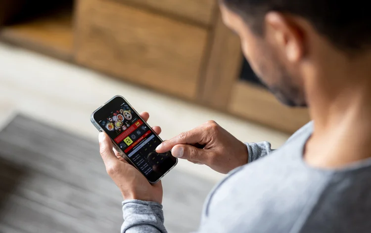 Man gambling online on a football match using his cell phone - lifestyle concepts (Getty/Getty Images)