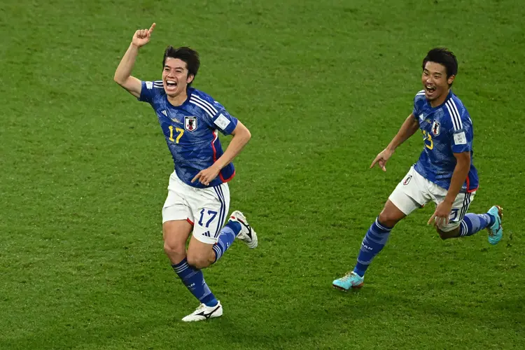 TOPSHOT - Japan's midfielder #17 Ao Tanaka celebrates scoring his team's second goal with his teammates during the Qatar 2022 World Cup Group E football match between Japan and Spain at the Khalifa International Stadium in Doha on December 1, 2022. (Photo by Jewel SAMAD / AFP) (Photo by JEWEL SAMAD/AFP via Getty Images) (JEWEL SAMAD/AFP/Getty Images)