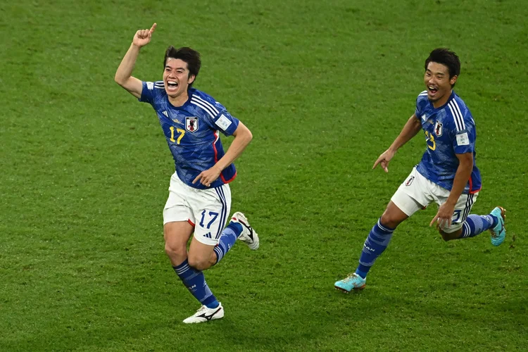 TOPSHOT - Japan's midfielder #17 Ao Tanaka celebrates scoring his team's second goal with his teammates during the Qatar 2022 World Cup Group E football match between Japan and Spain at the Khalifa International Stadium in Doha on December 1, 2022. (Photo by Jewel SAMAD / AFP) (Photo by JEWEL SAMAD/AFP via Getty Images) (JEWEL SAMAD/AFP/Getty Images)