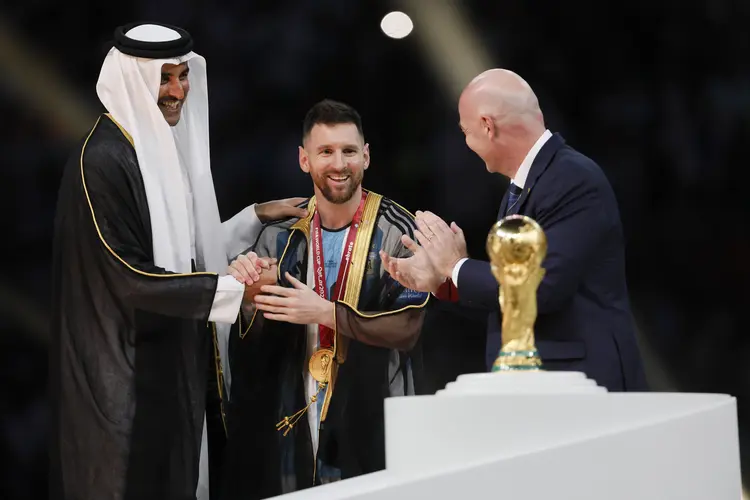 LUSAIL CITY, QATAR - DECEMBER 18: Amim Bin Hamad Al Thani, Emir of Qatar, Lionel Messi of Argentina with gold medal and Gianni Infantino, President of FIFA after the FIFA World Cup Qatar 2022 Final match between Argentina and France at Lusail Stadium on December 18, 2022 in Lusail City, Qatar. (Photo by Richard Sellers/Getty Images) (Richard Sellers/Getty Images)