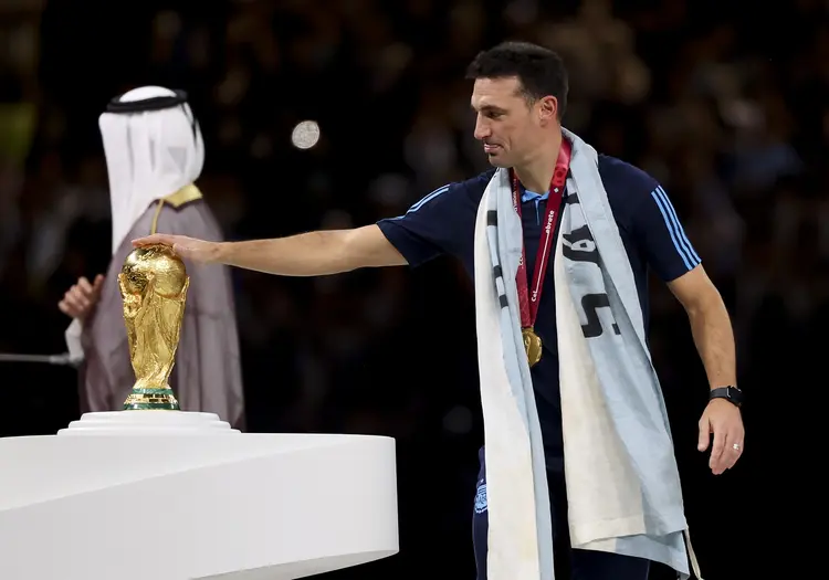 LUSAIL CITY, QATAR - DECEMBER 18: Coach of Argentina Lionel Scaloni touching the World Cup during the trophy ceremony following the FIFA World Cup Qatar 2022 Final match between Argentina and France at Lusail Stadium on December 18, 2022 in Lusail City, Qatar. (Photo by Jean Catuffe/Getty Images) (Jean Catuffe/Getty Images)