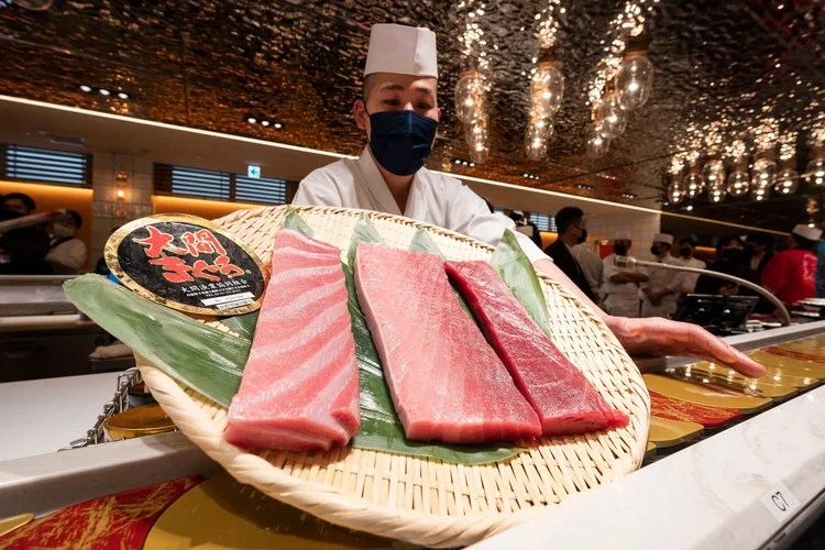 A sushi chef displays freshly cut bluefin tuna - which was purchased earlier in the day for over 270,000 USD at the first tuna auction of the New Year - at the Sushi Ginza Onodera main store in Omotesando in Tokyo on January 5, 2023. - Michelin-starred sushi restaurant Onodera Group and Japanese wholesaler Yamayuki forked out 273,000 USD for the 212-kilo bluefin tuna in the auction at Tokyo's Toyosu fish market early morning on January 5. (Photo by Richard A. Brooks / AFP) (Photo by RICHARD A. BROOKS/AFP via Getty Images) (RICHARD A. BROOKS/Getty Images)