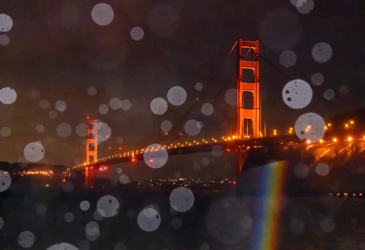 The Golden Gate Bridge is seen through a mix of rain and splashing bay water in Sausalito, California on January 5, 2023. - Damaging winds, excessive rainfall and extremely heavy snow are expected to wallop California and southern Oregon through January 5 as a series of winter storms rip across the western US coast, prompting the Golden State's governor to declare an emergency. (Photo by JOSH EDELSON / AFP) (Photo by JOSH EDELSON/AFP via Getty Images) (JOSH EDELSON/Getty Images)