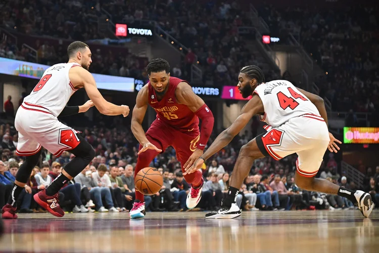 CLEVELAND, OHIO - JANUARY 02: Zach LaVine #8 and Patrick Williams #44 of the Chicago Bulls try to stop Donovan Mitchell #45 of the Cleveland Cavaliers from driving to the basket during the first half at Rocket Mortgage Fieldhouse on January 02, 2023 in Cleveland, Ohio. NOTE TO USER: User expressly acknowledges and agrees that, by downloading and or using this photograph, User is consenting to the terms and conditions of the Getty Images License Agreement. (Photo by Jason Miller/Getty Images) (Jason Miller/Getty Images)