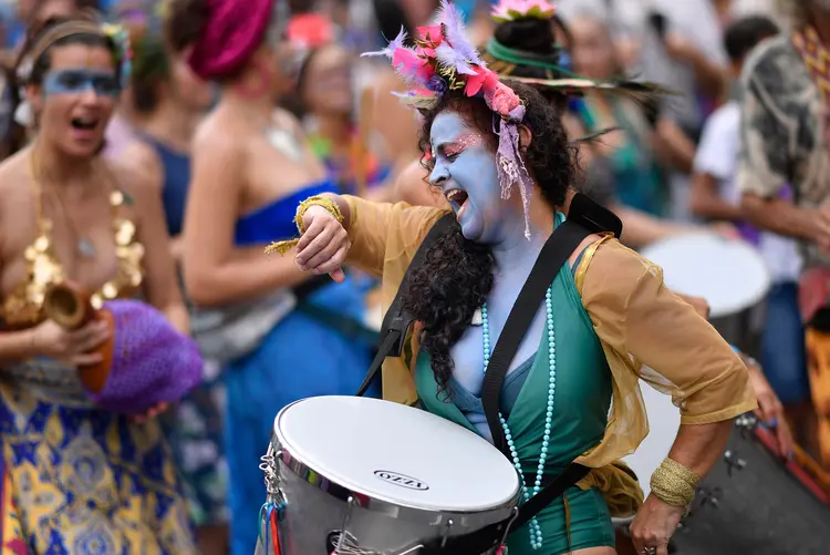 A member of the Pena de Pavao de Krishna traditional carnival group, which celebrates Indian deities, plays the drum as she performs in Belo Horizonte, Brazil, on February 23, 2020. - The group added more accelerated northern rhythms to its repertoire in a way to raise awareness of the importance of the Amazon rainforest and the worrying rates that it is burning at. (Photo by DOUGLAS MAGNO / AFP) (Photo by DOUGLAS MAGNO/AFP via Getty Images) (DOUGLAS MAGNO/AFP/Getty Images)