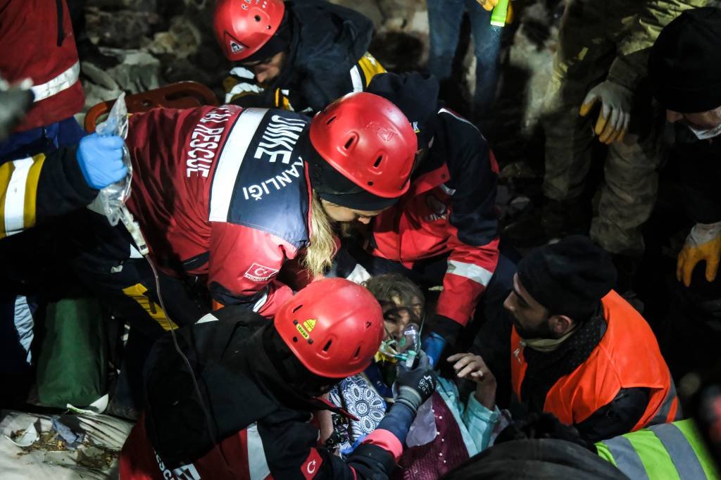 Agachados sob lajes de concreto e sussurrando "inshallah" (Graças a Deus, em árabe), os socorristas cuidadosamente enfiaram a mão nos escombros e passaram pela o bebê (Mehmet Kacmaz/Getty Images)