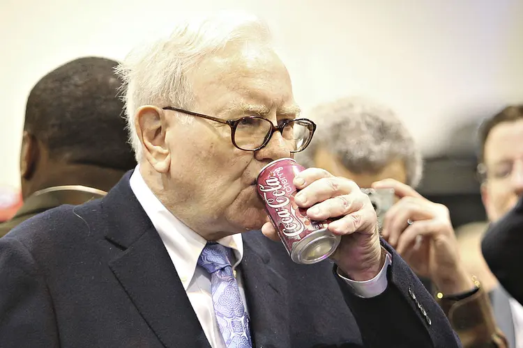 Warren Buffett, chief executive officer of Berkshire Hathaway, drinks a Cherry Coca-Cola as he tours the exhibition floor prior to the Berkshire Hathaway annual meeting in Omaha, Nebraska, U.S., on Saturday, May 1, 2010. Buffett, the Wall Street critic who invested $5 billion in Goldman Sachs Group Inc., said he supports the bank's Chief Executive Officer Lloyd Blankfein '100 percent' after the firm was sued by regulators for fraud. Photographer: Daniel Acker/Bloomberg via Getty Images (Daniel Acker/Bloomberg via/Getty Images)