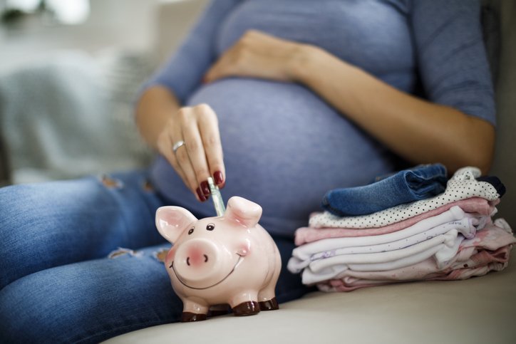Pregnant woman saving up for baby (damircudic/Getty Images)