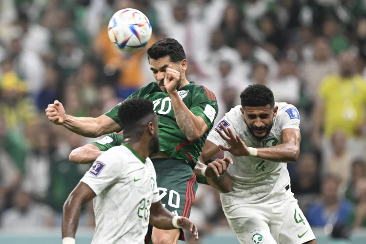 Mexico's forward #20 Henry Martin (C) fights for the ball with Saudi Arabia's midfielder #26 Riyadh Sharahili (L) and Saudi Arabia's defender #04 Abdulelah Al-Amri (R) during the Qatar 2022 World Cup Group C football match between Saudi Arabia and Mexico at the Lusail Stadium in Lusail, north of Doha on November 30, 2022. (Photo by Alfredo ESTRELLA / AFP) (Photo by ALFREDO ESTRELLA/AFP via Getty Images) (ALFREDO ESTRELLA/Getty Images)