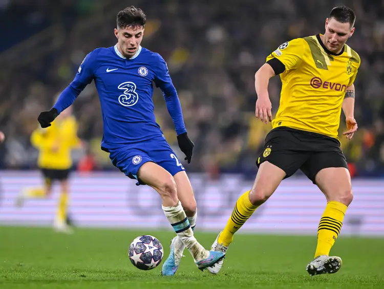 DORTMUND, GERMANY - FEBRUARY 15: Kai Harvertz of Chelsea FC and Niklas Suele of Borussia Dortmund battle for the ball during the UEFA Champions League round of 16 leg one match between Borussia Dortmund and Chelsea FC at Signal Iduna Park on February 15, 2023 in Dortmund, Germany. (Photo by Harry Langer/DeFodi Images via Getty Images) (Harry Langer/DeFodi/Getty Images)