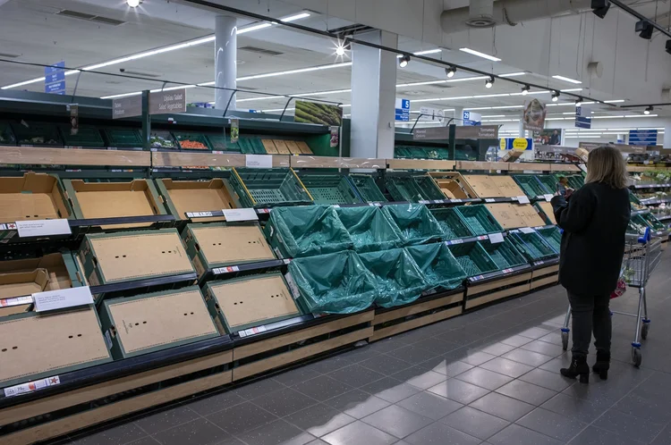 CARDIFF, WALES - FEBRUARY 25: A woman photographs empty shelves in a supermarket on February 25, 2023 in Cardiff, Wales. Aldi, Asda, Morrisons and Tesco have placed limits on the number of tomatoes, cucumbers and peppers customers can purchase due to shortages. The UK government has said this is due to extreme weather in Spain and north Africa which has affected harvests. (Photo by Matthew Horwood/Getty Images) (Matthew Horwood/Getty Images)