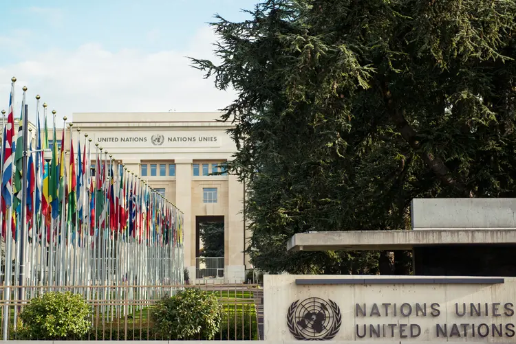 Image of national flags in front of United Nations headquarters in Geneva, Switzerland. (iStock/Getty Images)