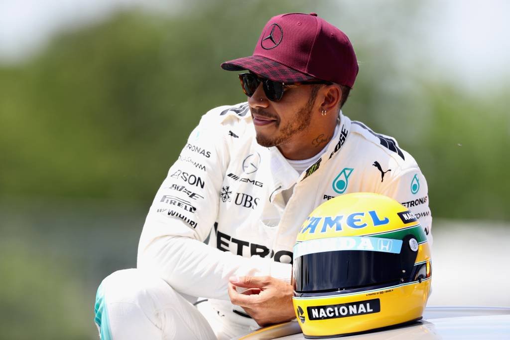 MONTREAL, QC - JUNE 10:  Pole sitter Lewis Hamilton of Great Britain and Mercedes GP with a commemorative helmet of F1 legend Ayrton Senna after he beat the previous record of 65 pole positions during qualifying for the Canadian Formula One Grand Prix at Circuit Gilles Villeneuve on June 10, 2017 in Montreal, Canada.  (Photo by Mark Thompson/Getty Images) (Mark Thompson/Getty Images)