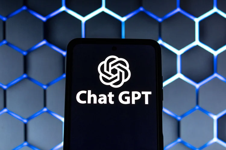 Photo illustration showing ChatGPT and OpenAI research laboratory logo and inscription at a mobile phone smartphone screen with a blurry background. Open AI is an app using artificial intelligence technology. Italy is the first European country to ban and block the robot Chat GPT application and website. ChatGPT is an artificial-intelligence (AI) chatbot developed by OpenAI and launched in November 2022 using reinforcement learning techniques both from machine and human feedback. Amsterdam, the Netherlands on April 1, 2023 (Photo by Nicolas Economou/NurPhoto via Getty Images) (Nicolas Economou/NurPhoto/Getty Images)