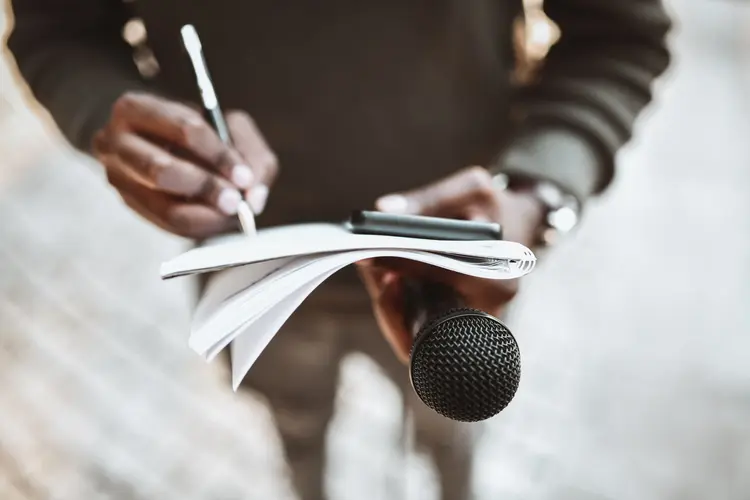 African Male Journalist Writing Down Questions And Preparing Before Press Conference Starts (AleksandarGeorgiev/Getty Images)