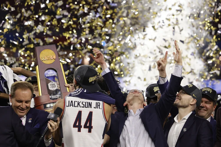 HOUSTON, TEXAS - APRIL 03: Head coach Dan Hurley of the Connecticut Huskies reacts as Andre Jackson Jr. #44 holds the championship trophy after defeating the San Diego State Aztecs 76-59 during the NCAA Men's Basketball Tournament National Championship game at NRG Stadium on April 03, 2023 in Houston, Texas. (Photo by Carmen Mandato/Getty Images) (Carmen Mandato/Getty Images)