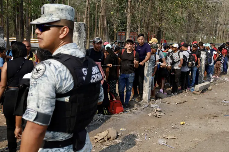 TAPACHULA, MEXICO - APRIL 26: Police officer controls access at immigration checkpoint on April 26, 2023 in Tapachula, Mexico. Thousands of migrants, who were detained for months in the south of Mexico, formed a new caravan in protest aiming to reach Mexico City and demand changes in the way migrants are treated. (Photo by Jose Torres/Agencia Press South/Getty Images) (Jose Torres/Getty Images)