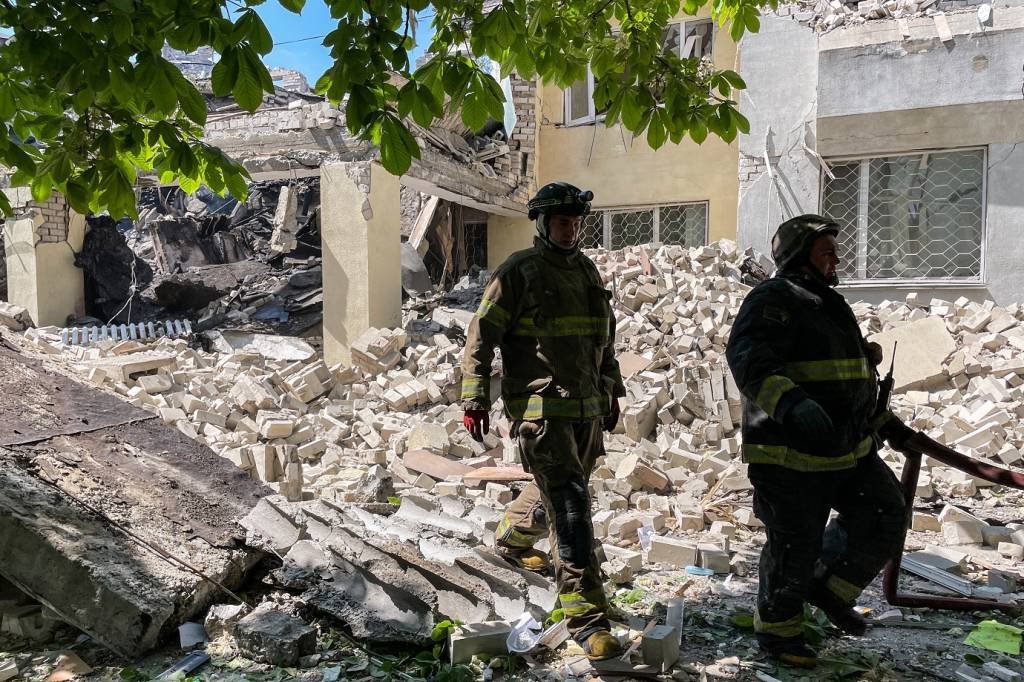 KHERSON, UKRAINE - MAY 15: Rescuers work amid rubble at the site of the Russian shelling on May 15, 2023 in Kherson, Ukraine. Around 4 a.m. on May 15, the Russian military launched a kamikaze drone on Kherson. There was a direct hit to the building of an educational institution, it was destroyed. There have been no casualties or injuries. (Photo by Ihor Pedchenko/Suspilne Ukraine/JSC "UA:PBC"/Global Images Ukraine via Getty Images) (AFP/AFP Photo)