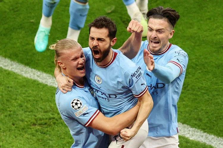 MANCHESTER, ENGLAND - MAY 17: Bernardo Silva of Manchester City celebrates with teammates Erling Haaland and Jack Grealish after scoring the teams second goal during the UEFA Champions League semi-final second leg match between Manchester City FC and Real Madrid at Etihad Stadium on May 17, 2023 in Manchester, England. (Photo by Matt McNulty - Manchester City/Manchester City FC via Getty Images) (Matt McNulty/Getty Images)