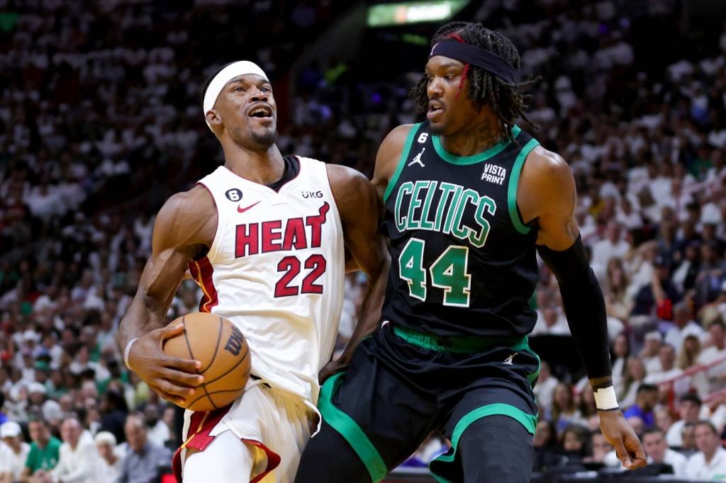 MIAMI, FLORIDA - MAY 21: Jimmy Butler #22 of the Miami Heat drives against Robert Williams III #44 of the Boston Celtics during the third quarter in game three of the Eastern Conference Finals at Kaseya Center on May 21, 2023 in Miami, Florida. NOTE TO USER: User expressly acknowledges and agrees that, by downloading and or using this photograph, User is consenting to the terms and conditions of the Getty Images License Agreement. (Photo by Megan Briggs/Getty Images) (Megan Briggs/Getty Images)