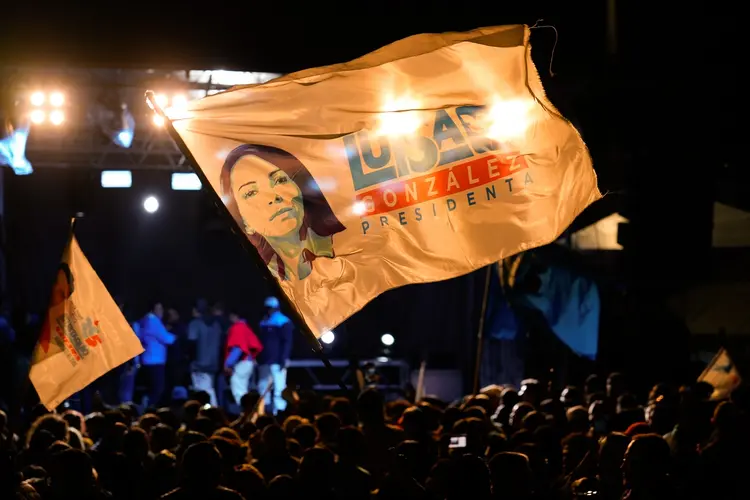 A supporter of Luisa Gonzalez, presidential candidate for the Revolucion Ciudadana party, waves a flag during an election night rally at the party headquarters in Quito, Ecuador, on Sunday, Aug. 20, 2023. Ecuador's presidential race will be decided in an October runoff between socialist candidate Gonzalez and entrepreneur Daniel Noboa, providing contrasting visions for how to bring prosperity to a violence-torn country. Photographer: Misha Vallejo/Bloomberg via Getty Images (Misha Vallejo/Bloomberg/Getty Images)