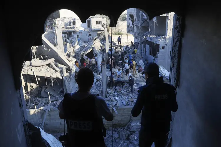 Palestinians inspect their destroyed homes following Israeli bombardment in Rafah in the southern Gaza Strip, on October 18, 2023, amid ongoing battles between Israel and the Palestinian group Hamas. US President Joe Bidden landed in Tel Aviv on October 18 as Middle East anger flared after hundreds were killed in a hospital blast in war-torn Gaza, for which Israel and the Palestinians immediately traded blame. (Photo by SAID KHATIB / AFP) (SAID KHATIB/AFP)