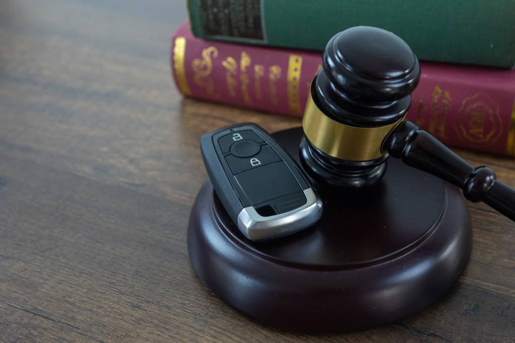 Close up of wooden judge gavel and car keys.Car accident lawsuit concept.