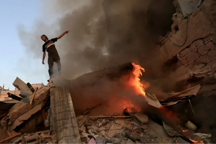 Edifício em chama em kHan Yunis, sul da Faixa de Gaza (Adel Zaanoun/AFP)
