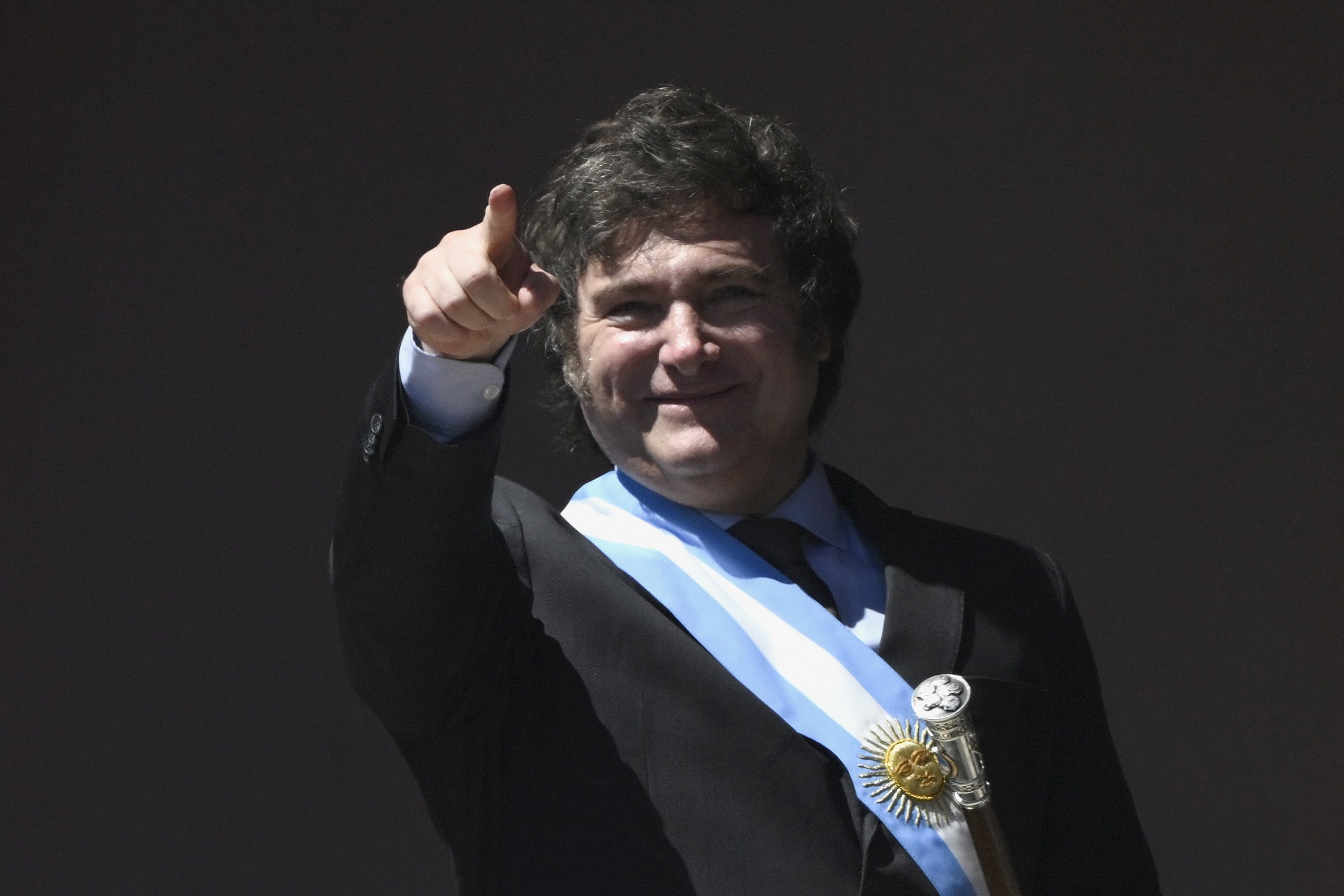 Argentina's new president, Javier Milei, gestures from a balcony of the Casa Rosada government palace during his inauguration day in Buenos Aires on December 10, 2023. Libertarian economist Javier Milei was sworn in Sunday as Argentina's president, after a resounding election victory fuelled by fury over the country's economic crisis. (Photo by Luis ROBAYO / AFP)