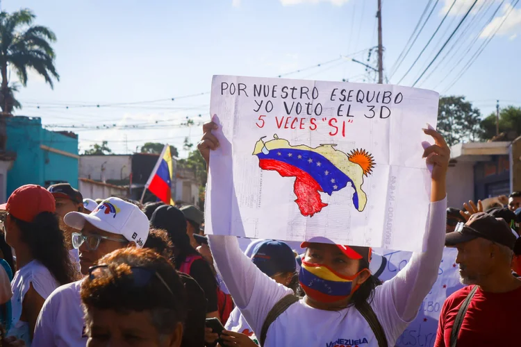 Manifestante exibe mapa da Venezuela com parte da Guiana anexada (Venezuela Toda no X/Reprodução)