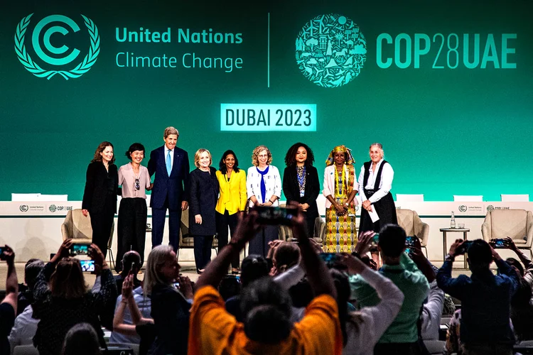 Hillary Clinto, à esquerda de John Kerry, em palco na COP28, em Dubai (Leandro Fonseca/Exame)