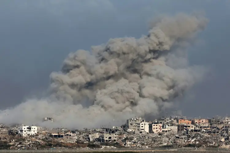Foto tirada no sul de Israel, perto da fronteira com a Faixa de Gaza, mostra fumaça durante um bombardeio israelense em 9 de dezembro de 2023 (AFP/Reprodução)