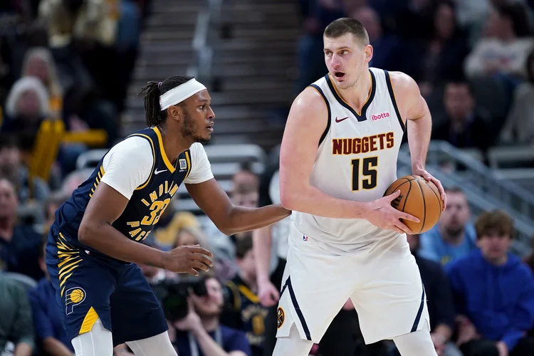 INDIANAPOLIS, INDIANA - JANUARY 23: Nikola Jokic #15 of the Denver Nuggets handles the ball while being guarded by Myles Turner #33 of the Indiana Pacers in the third quarter at Gainbridge Fieldhouse on January 23, 2024 in Indianapolis, Indiana. NOTE TO USER: User expressly acknowledges and agrees that, by downloading and or using this photograph, User is consenting to the terms and conditions of the Getty Images License Agreement. (Photo by Dylan Buell/Getty Images) (Dylan Buell/Getty Images)