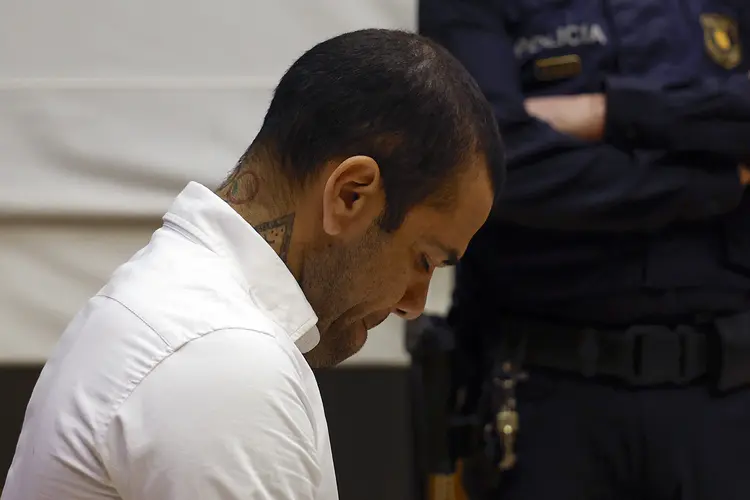 Brazilian footballer Dani Alves looks down during his trial at the High Court of Justice of Catalonia in Barcelona, on February 5, 2024. Brazilian footballer Dani Alves, a former star at Barca and PSG, goes on trial in Barcelona accused of raping a woman in a local nightclub. Prosecutors are asking for a nine-year prison sentence, followed by 10 years of conditional liberty. They are also asking he pay 150,000 euros ($162,000) in compensation to the woman. (Photo by ALBERTO ESTÉVEZ / POOL / AFP) (Photo by ALBERTO ESTEVEZ/POOL/AFP via Getty Images)