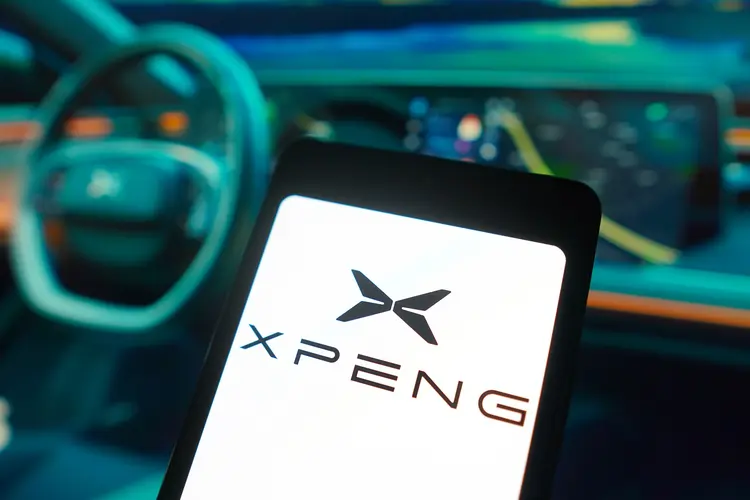 BRAZIL - 2024/01/29: In this photo illustration, the XPeng Motors logo is displayed on a smartphone screen and in the background, an electric car from the same brand. (Photo Illustration by Rafael Henrique/SOPA Images/LightRocket via Getty Images) (Rafael Henrique/SOPA Images/LightRocket /Getty Images)