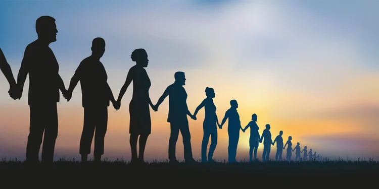 Concept of the human chain and solidarity with a group of aligned people who join hands to show that unity is strength. (Pict Rider/Getty Images)